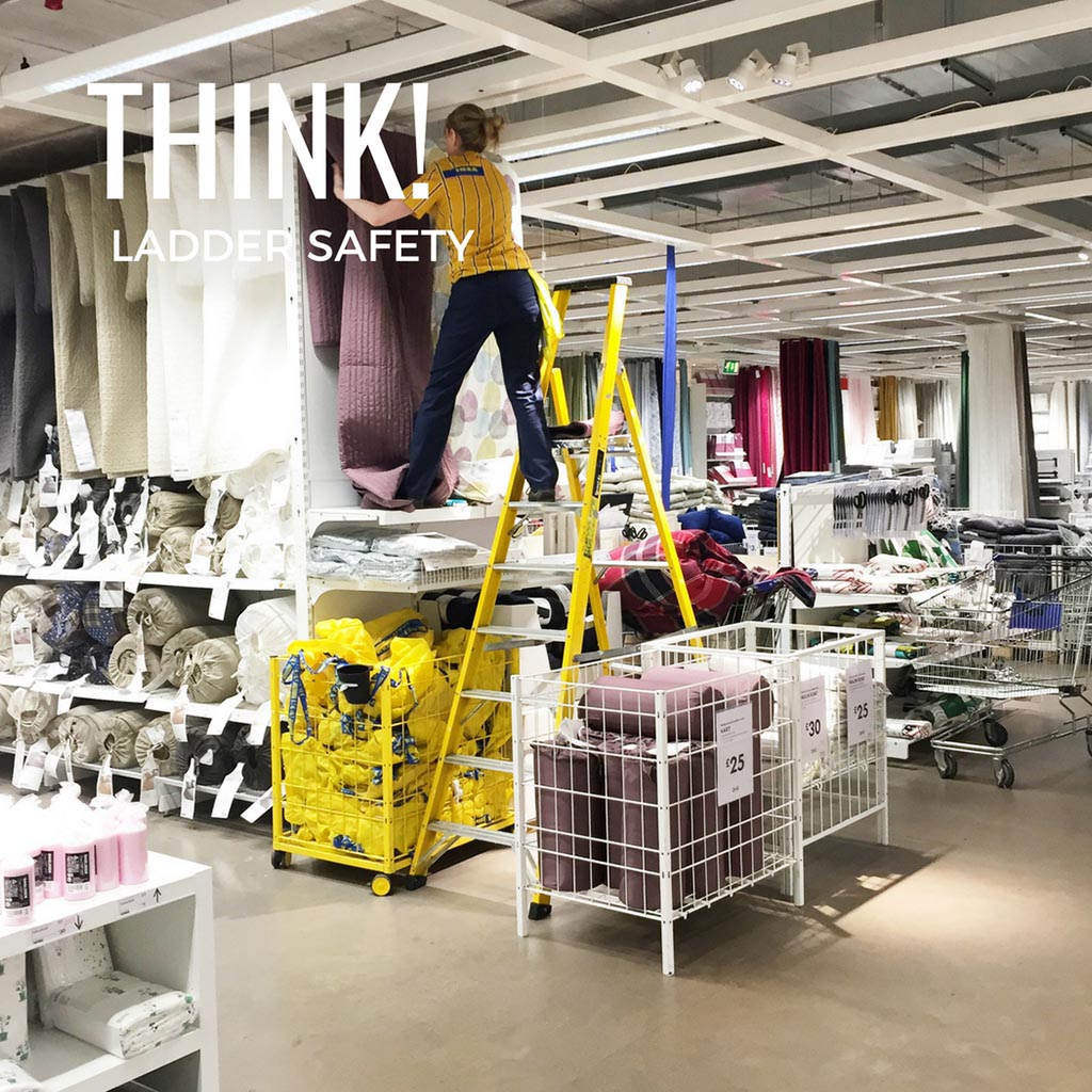 Worker at IKEA unsafely stepping off step ladder