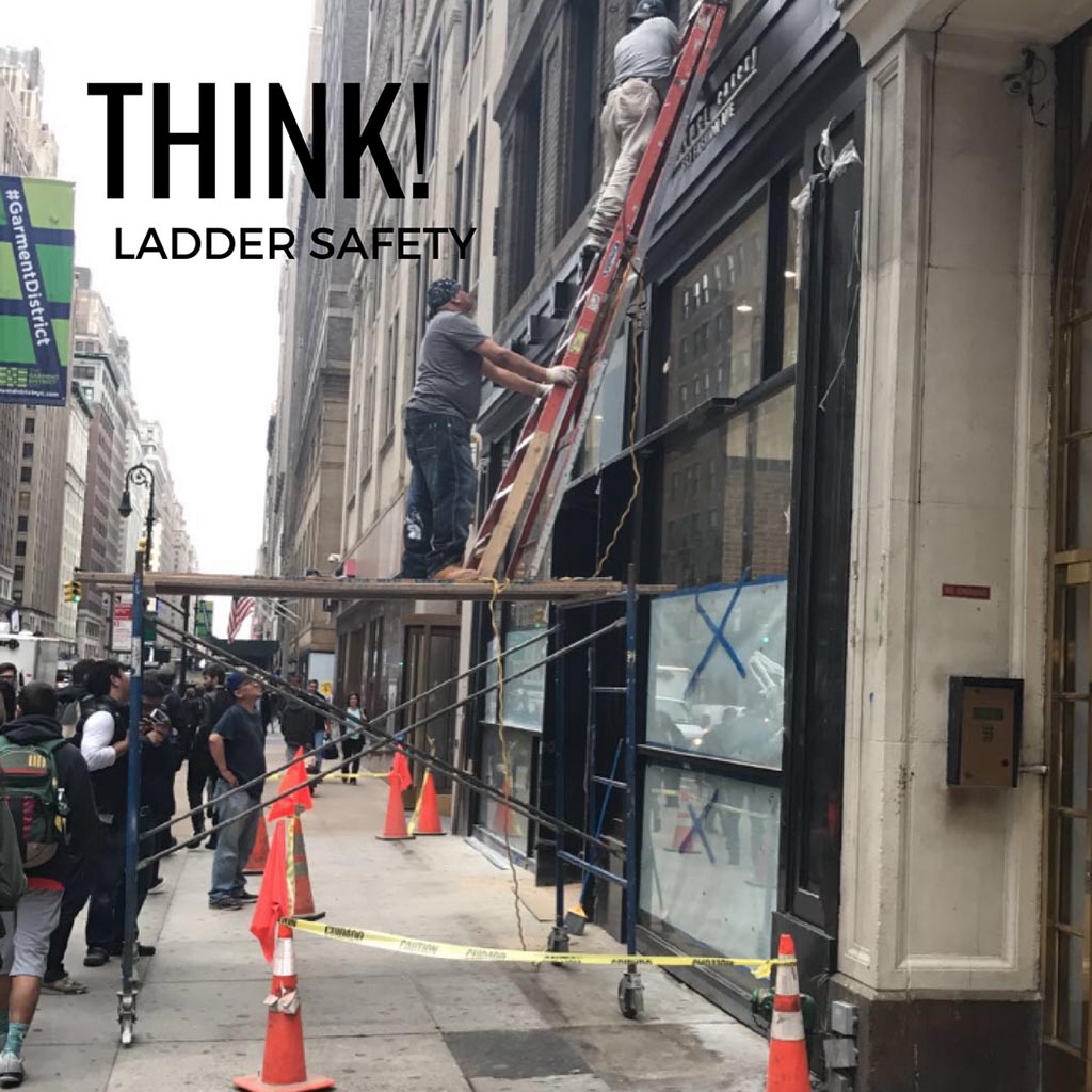Two ladder users working from two ladders stacked on top of each other in an unsafe way