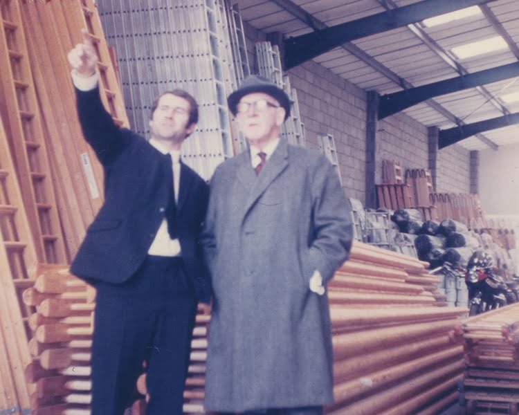 Current Chairman, Patrick Gray showing Founder, TB Davies around warehouse in the early 1970s